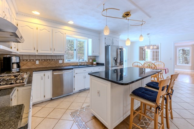 29 Stoneybrook Circle Andover, MA 01810 - Photo 13 of 41 a kitchen with granite countertop stainless steel appliances a sink a stove a counter space and a window