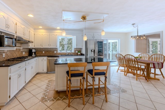 29 Stoneybrook Circle Andover, MA 01810 - Photo 14 of 41 a kitchen with stainless steel appliances granite countertop a table and chairs in it