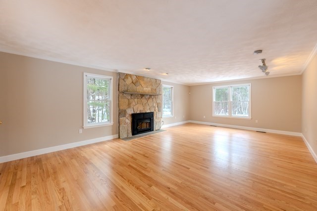 29 Stoneybrook Circle Andover, MA 01810 - Photo 19 of 41 an empty room with wooden floor fireplace and windows