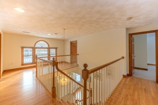 29 Stoneybrook Circle Andover, MA 01810 - Photo 24 of 41 a view of a hallway with wooden floor and table