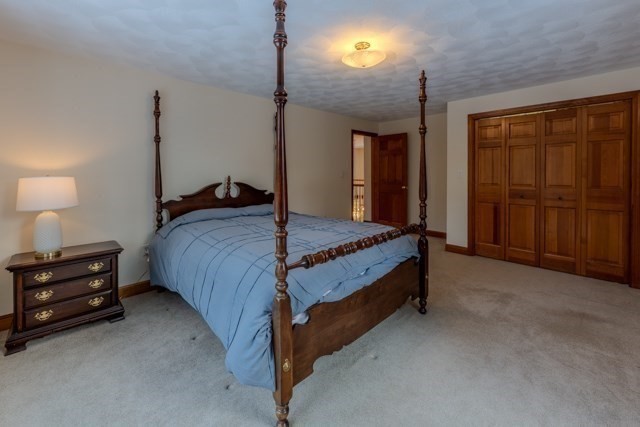 29 Stoneybrook Circle Andover, MA 01810 - Photo 37 of 41 a bed sitting in a room next to a lamp