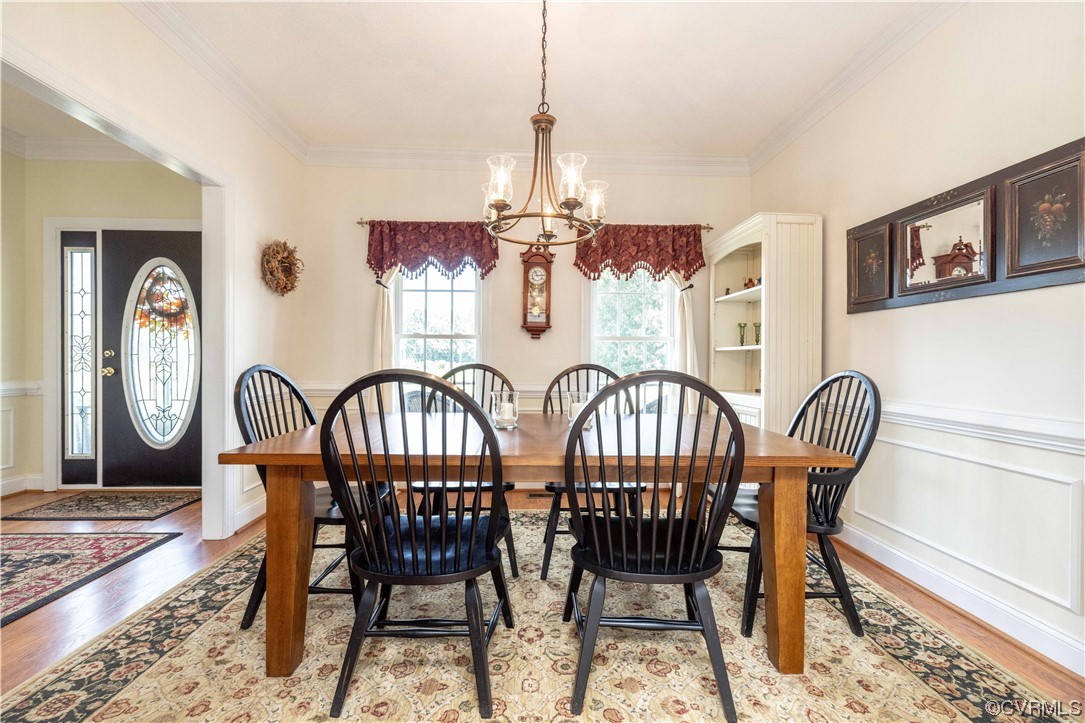 16211 River Road Chesterfield, VA 23838 - Photo 16 of 40 a view of a dining room with furniture a chandelier and wooden floor