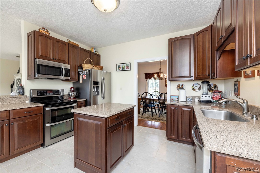 16211 River Road Chesterfield, VA 23838 - Photo 10 of 40 a kitchen with kitchen island granite countertop a sink stove and refrigerator