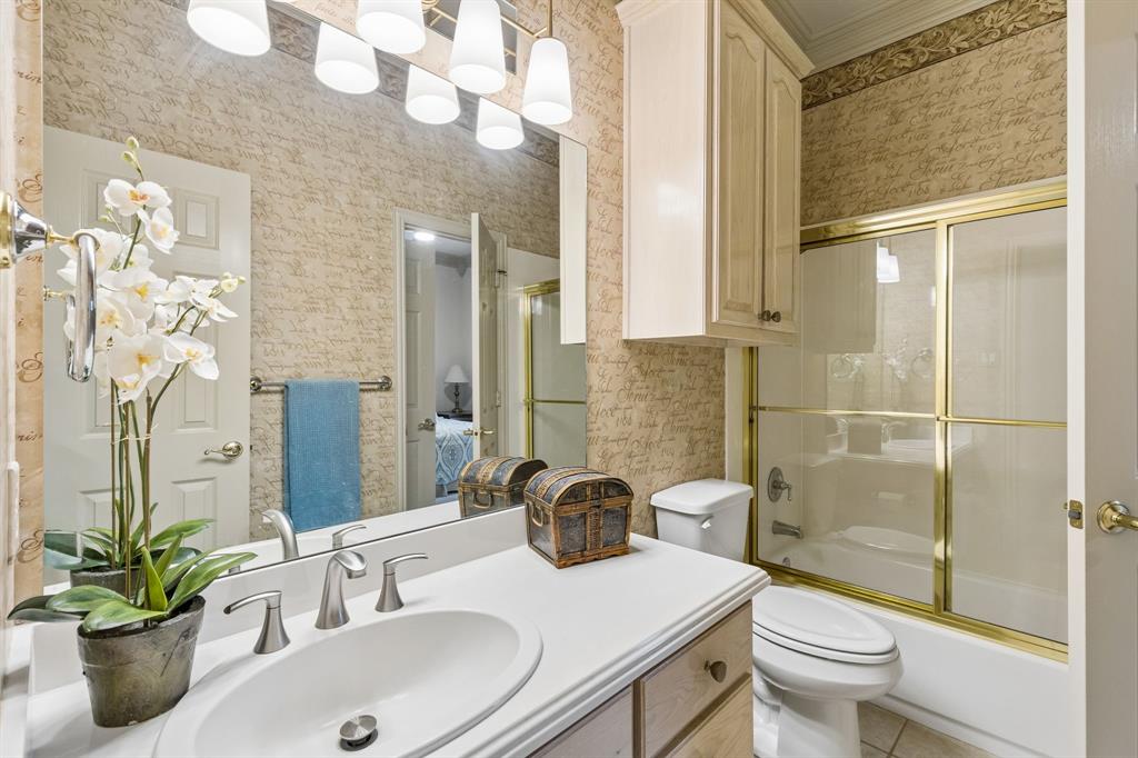 8517 Navigation Drive Rowlett, TX 75088 - Photo 26 of 39 a bathroom with a sink a toilet and shower
