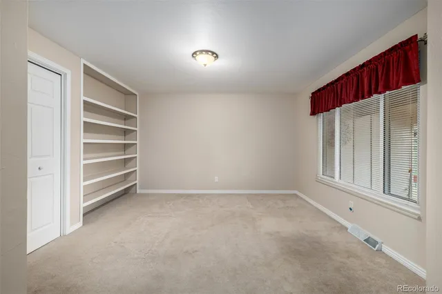 a view of a glass door with a balcony from a room