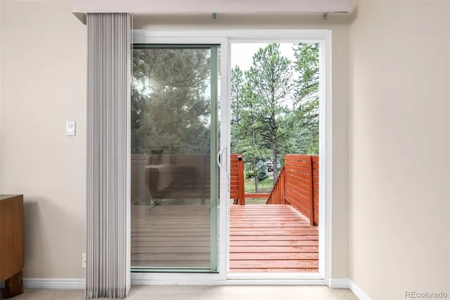 a backyard of a house with wooden floor and seating space
