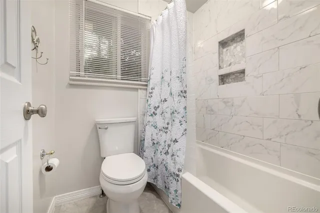 a view of a house with a big yard and large trees