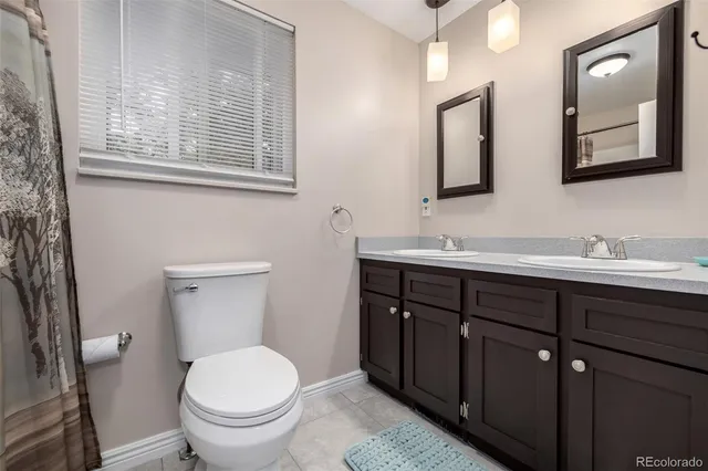 an aerial view of a house with a yard and large trees