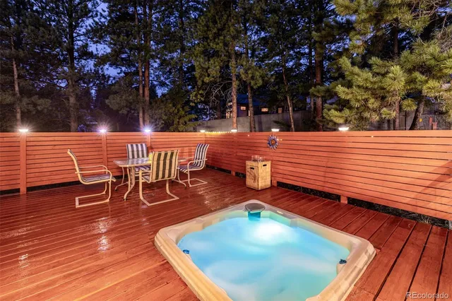 a view of a big room with windows and chandelier fan