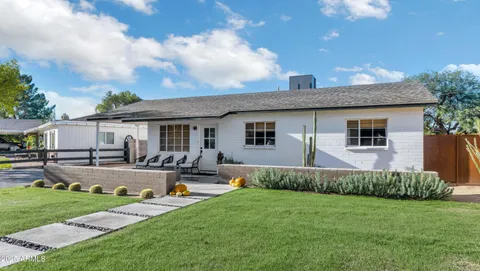 a front view of house with yard and patio