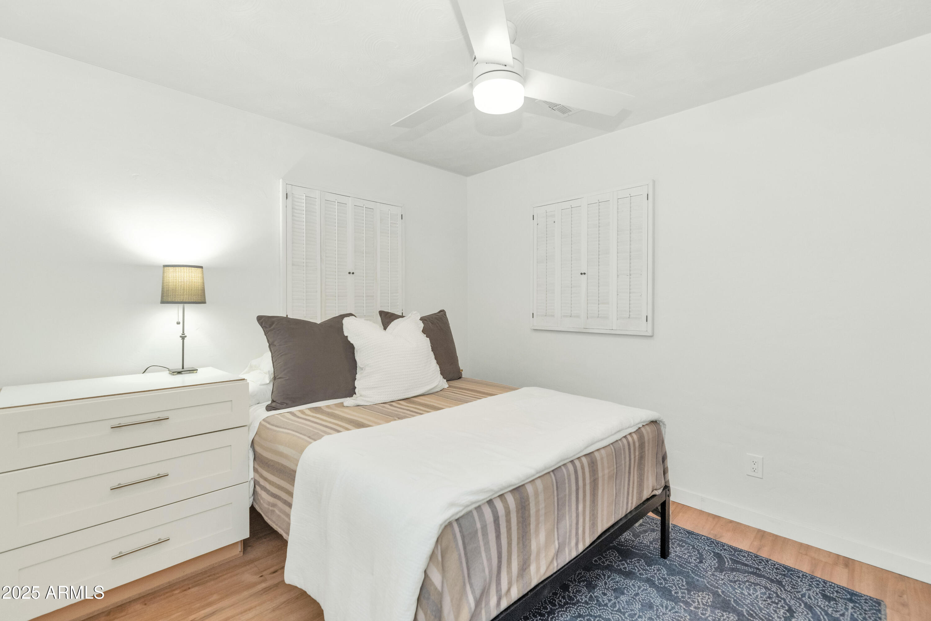 4549 East Campbell Avenue Phoenix, AZ 85018 - Photo 15 of 19 a bedroom with a bed and painting on the wall