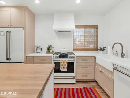 a kitchen with a stove oven and white cabinets
