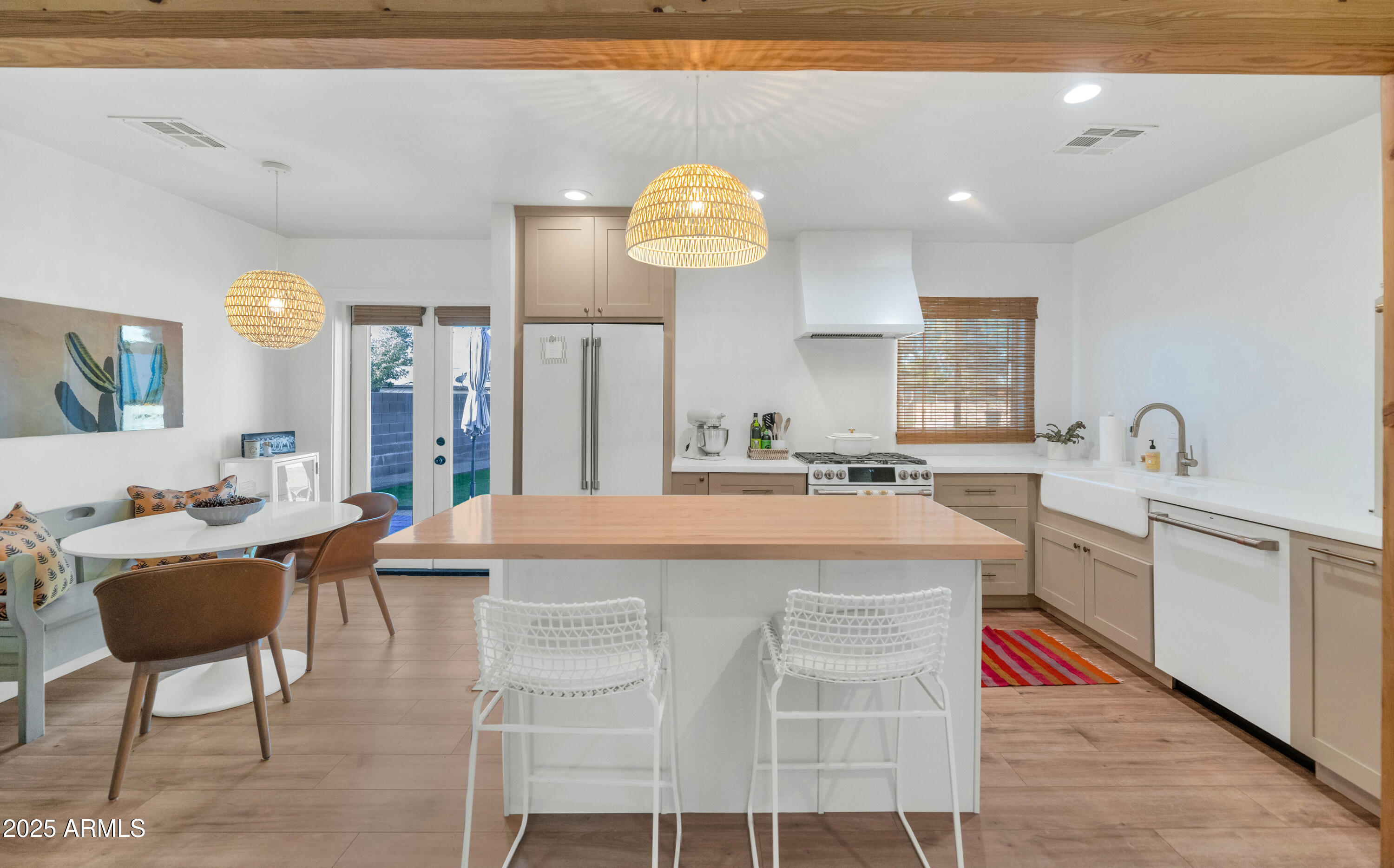 4549 East Campbell Avenue Phoenix, AZ 85018 - Photo 10 of 19 a large kitchen with kitchen island stainless steel appliances a table and chairs
