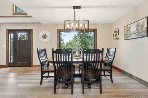 a view of a dining room with furniture window and wooden floor