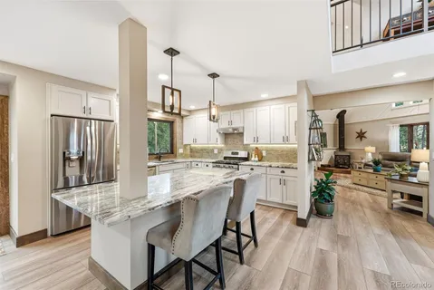 a kitchen with white cabinets and stove