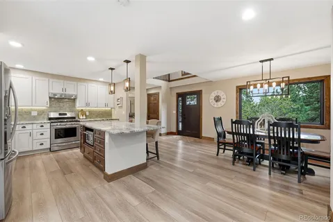 a kitchen with a table chairs microwave and cabinets