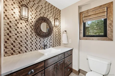 a bathroom with a sink a mirror and a toilet