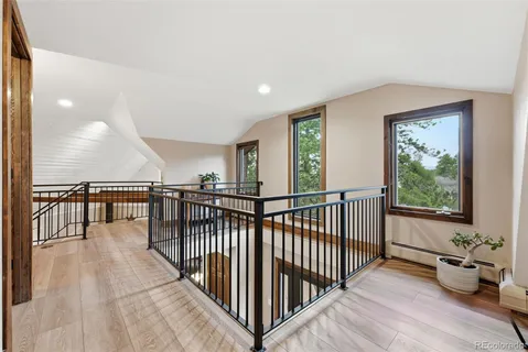 a view of a room with wooden floor and windows
