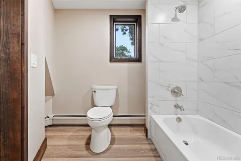 a bathroom with a toilet and a bathtub