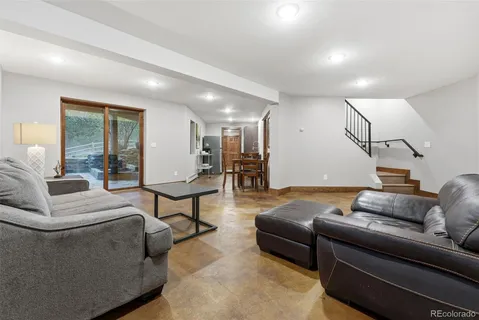 a living room with furniture and kitchen view