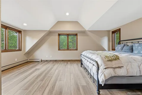 a spacious bedroom with a bed and a window