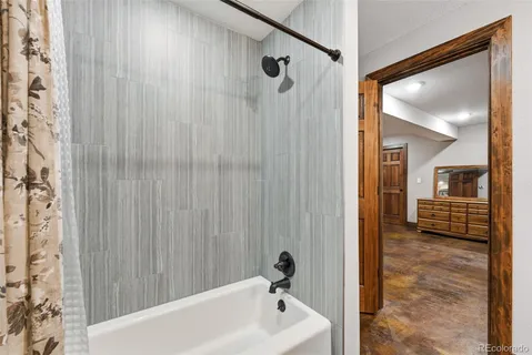 a bathroom with a tub and shower