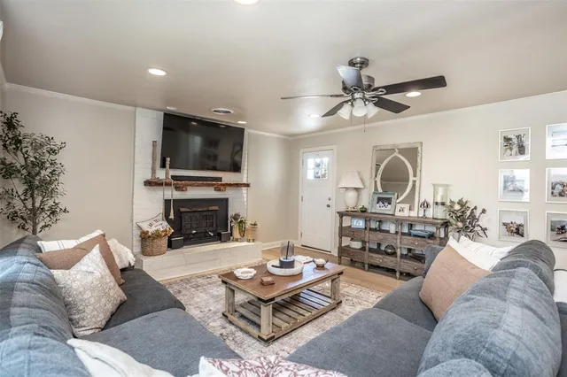 a living room with furniture a fireplace and a flat screen tv