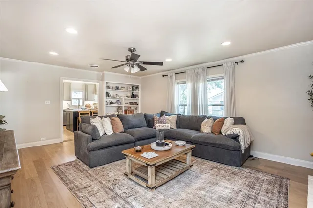 a living room with furniture and a wooden floor
