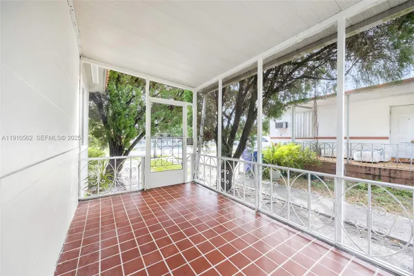 a view of a porch with wooden floor and outdoor space