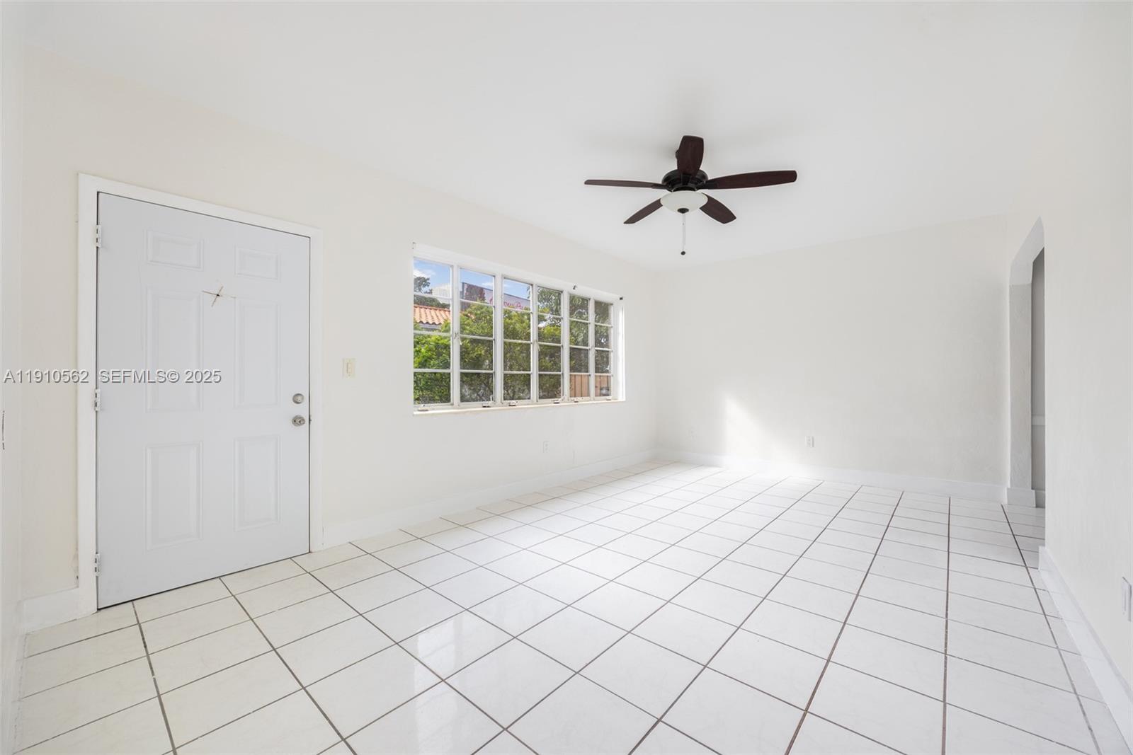 282 Northwest 41st Avenue Miami, FL 33126 - Photo 5 of 15 a view of an empty room and window