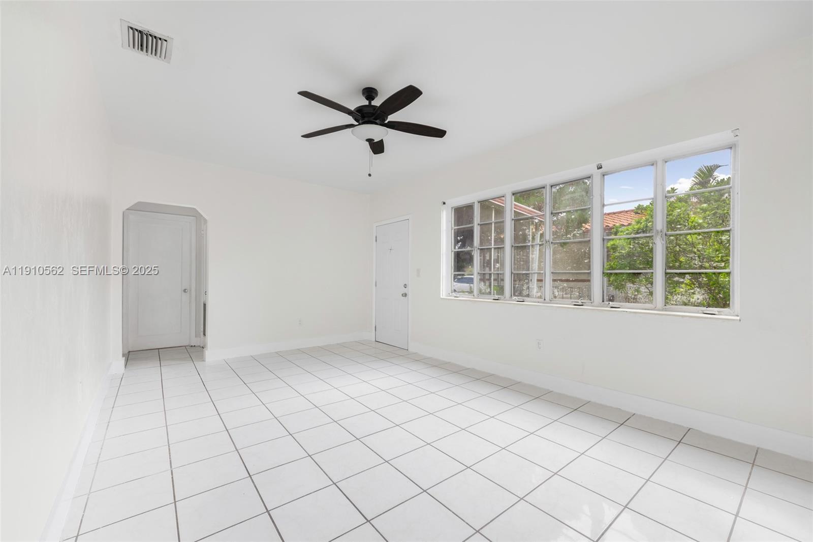 282 Northwest 41st Avenue Miami, FL 33126 - Photo 7 of 15 a view of an empty room with a window