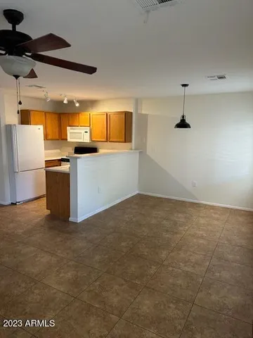 a kitchen with a refrigerator and microwave