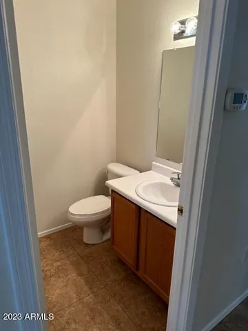 a bathroom with a toilet a sink and a mirror