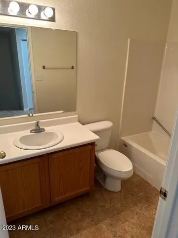 an empty room with windows and chandelier