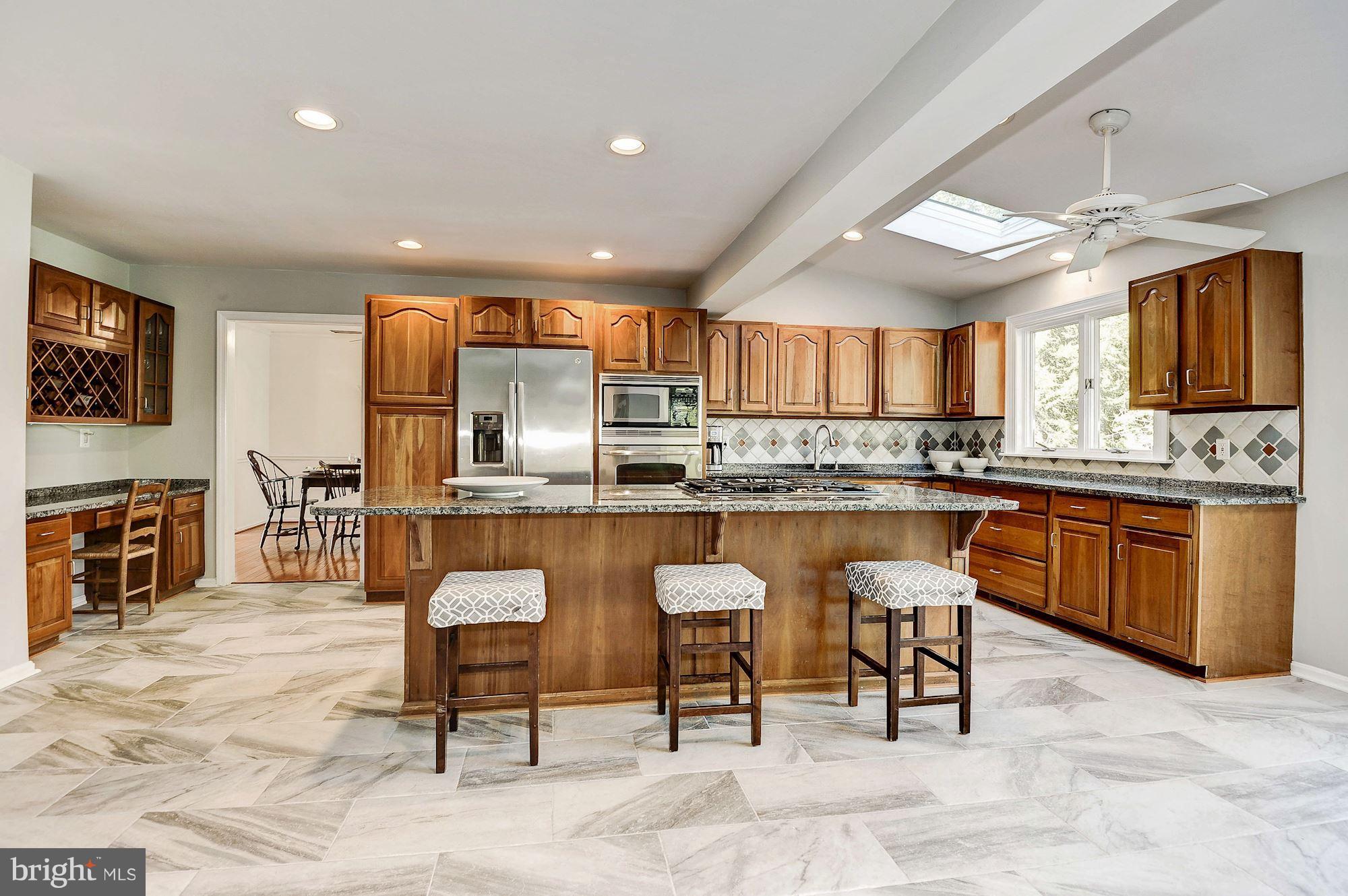 13361 Point Rider Lane Herndon, VA 20171 - Photo 9 of 30 Kitchen features built in desk & wine rack.
