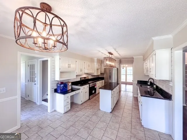 a kitchen with a sink a stove and cabinets