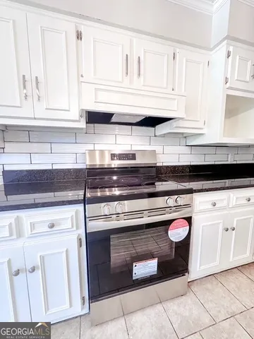a kitchen with stainless steel appliances granite countertop a sink and cabinets