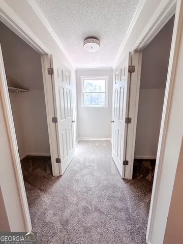 an empty room with a window and a ceiling fan