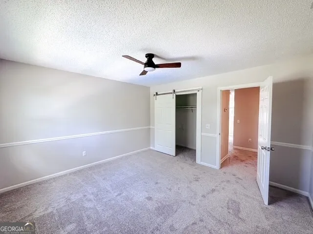 a view of hallway with porch and wooden floor