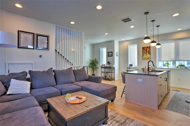 a living room with furniture and kitchen view