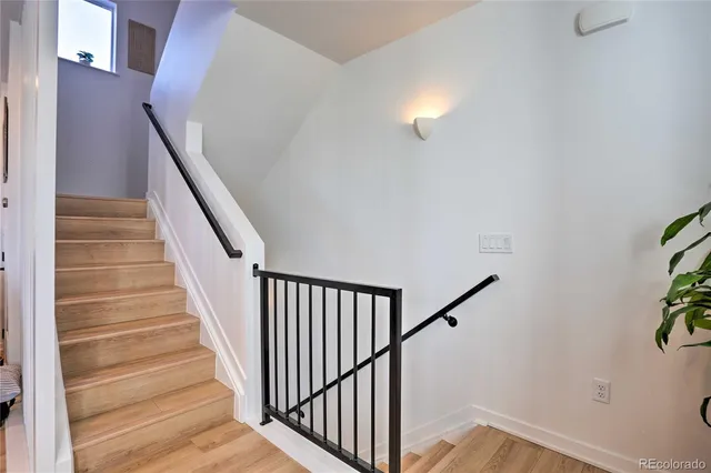 a view of staircase with railing and a chandelier