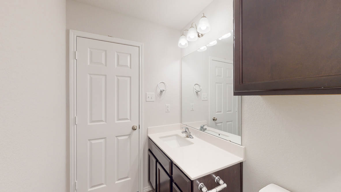 246 Water Wl Road Burnet, TX 78611 - Photo 13 of 16 a bathroom with a sink a mirror and a vanity