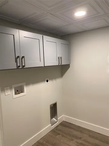 a kitchen with a dining table chairs and white cabinets