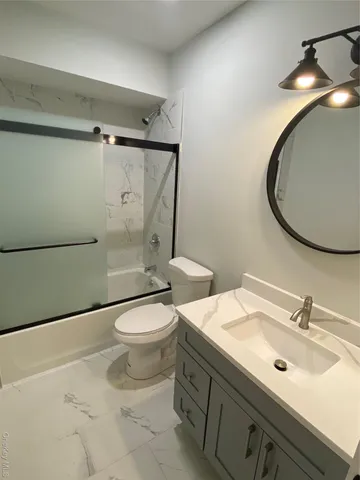 a view of a kitchen with wooden floor and cabinets