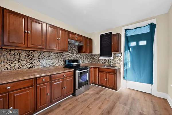 a kitchen with stainless steel appliances a refrigerator and a stove top oven