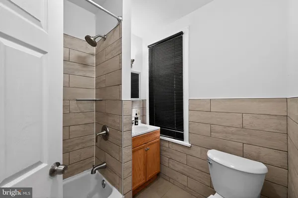 a view of empty room with wooden floor and cabinet