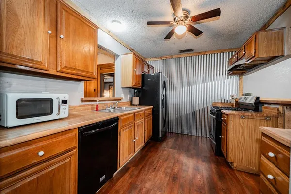 a kitchen with wooden floor and a sink