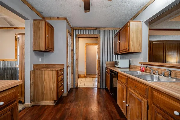 a kitchen with stainless steel appliances granite countertop a sink and a refrigerator