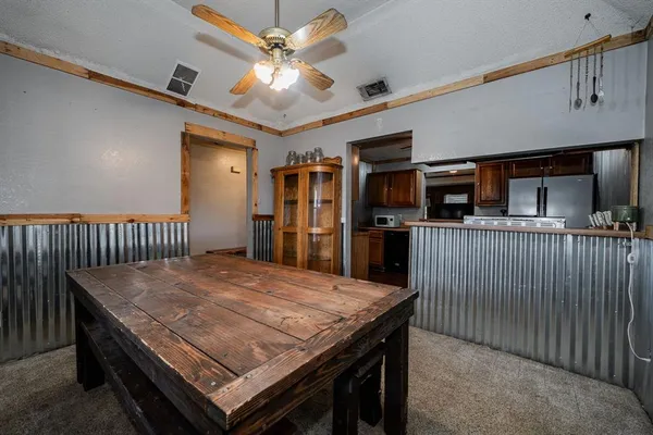 a spacious bedroom with a bed and a ceiling fan