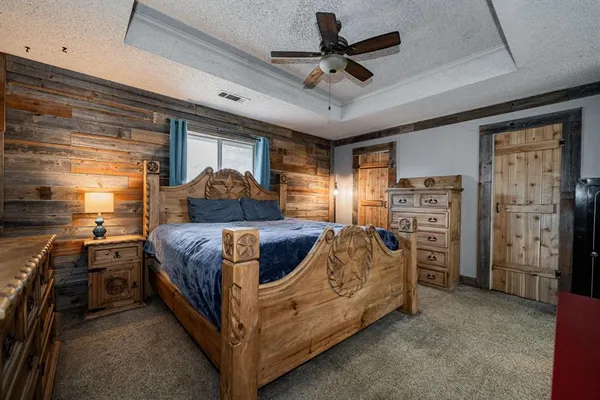 a bedroom with furniture and a flat tv screen